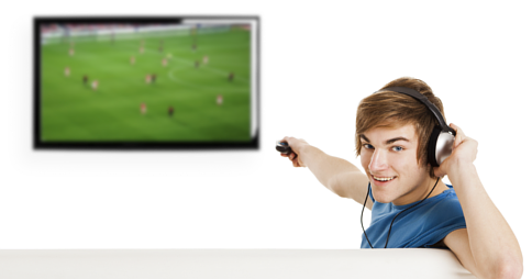 Man wearing headphones while pointing remote control at TV