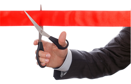 Businessman holding an open pair of scissors up to a line of red tape