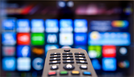 Remote control pointed at a Smart TV
