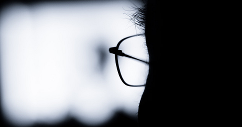 Silhouette of a man with glasses watching TV. Image credit: XiXiDu via Flickr