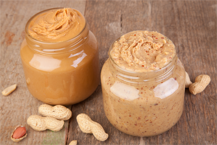 Two glass jars of peanut butter. Smooth on the left and crunchy on the right.