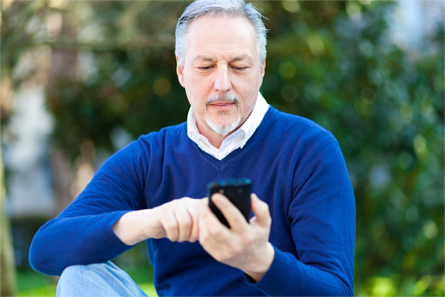 Mature man using a smartphone outdoors