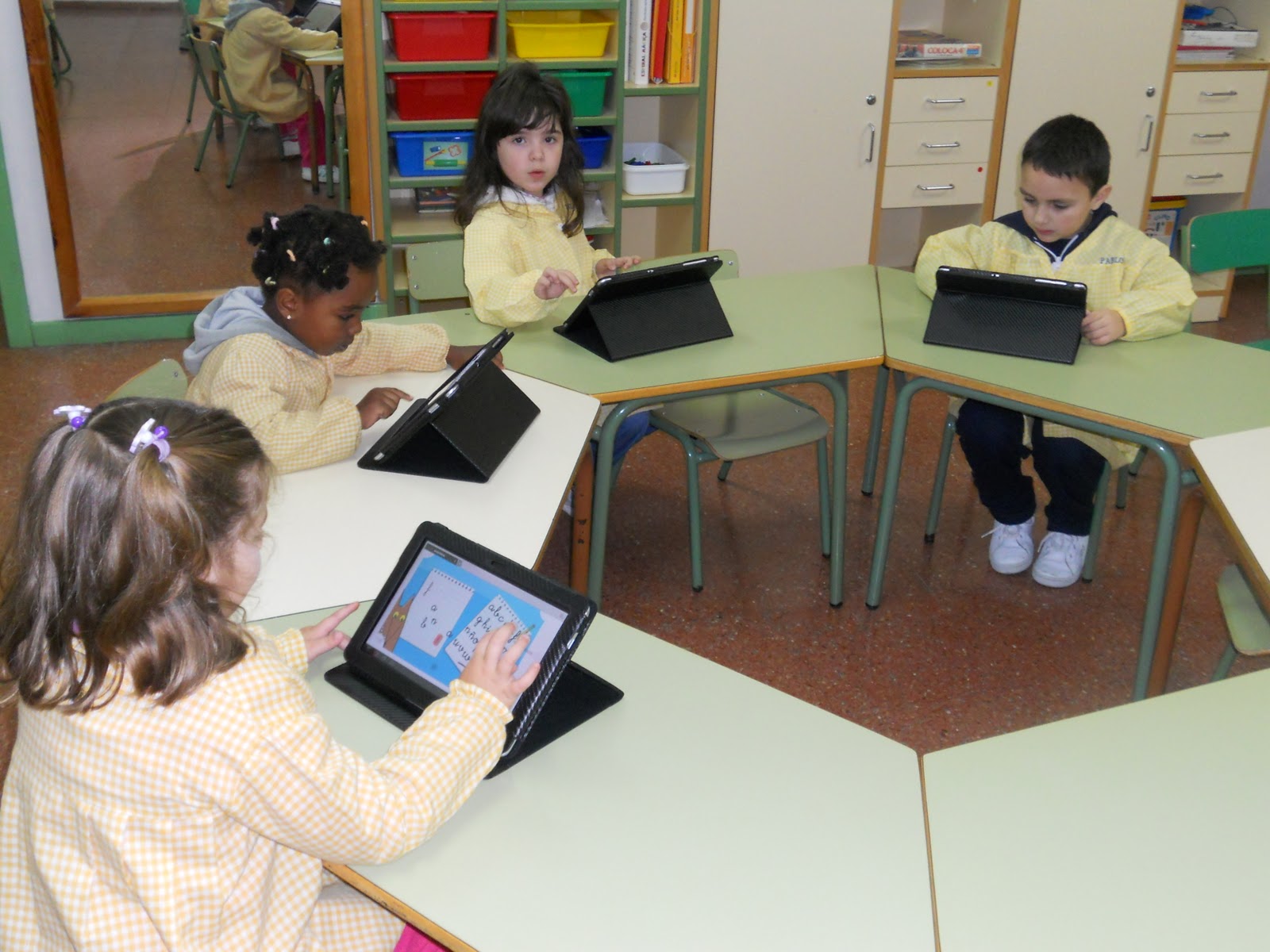 Kids using tablets in class