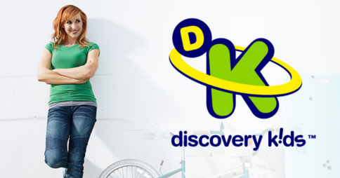 Kari Byron standing next to Discovery Kids logo