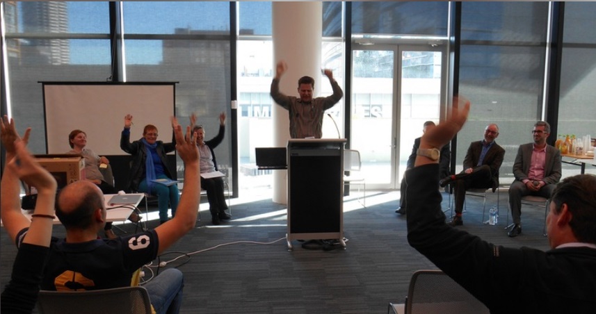 People raising their hands at the 2016 Perth Access Camp