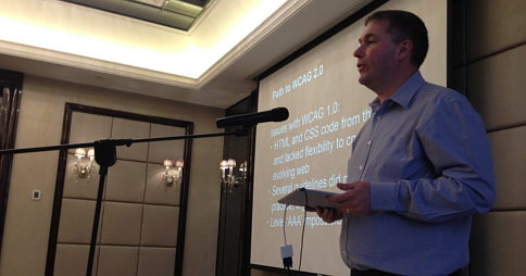 Dr Scott Hollier presenting the Professional Certificate in Web Accessibility. The presentation slide reads 'Path to WCAG 2.0' Dr Scott Hollier presenting the Professional Certificate in Web Accessibility. The presentation slide reads 'Path to WCAG 2.0'