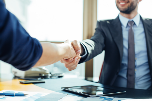 Businessman and businesswoman shaking hands