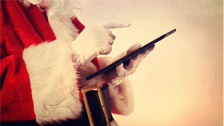 Santa Claus using a tablet device