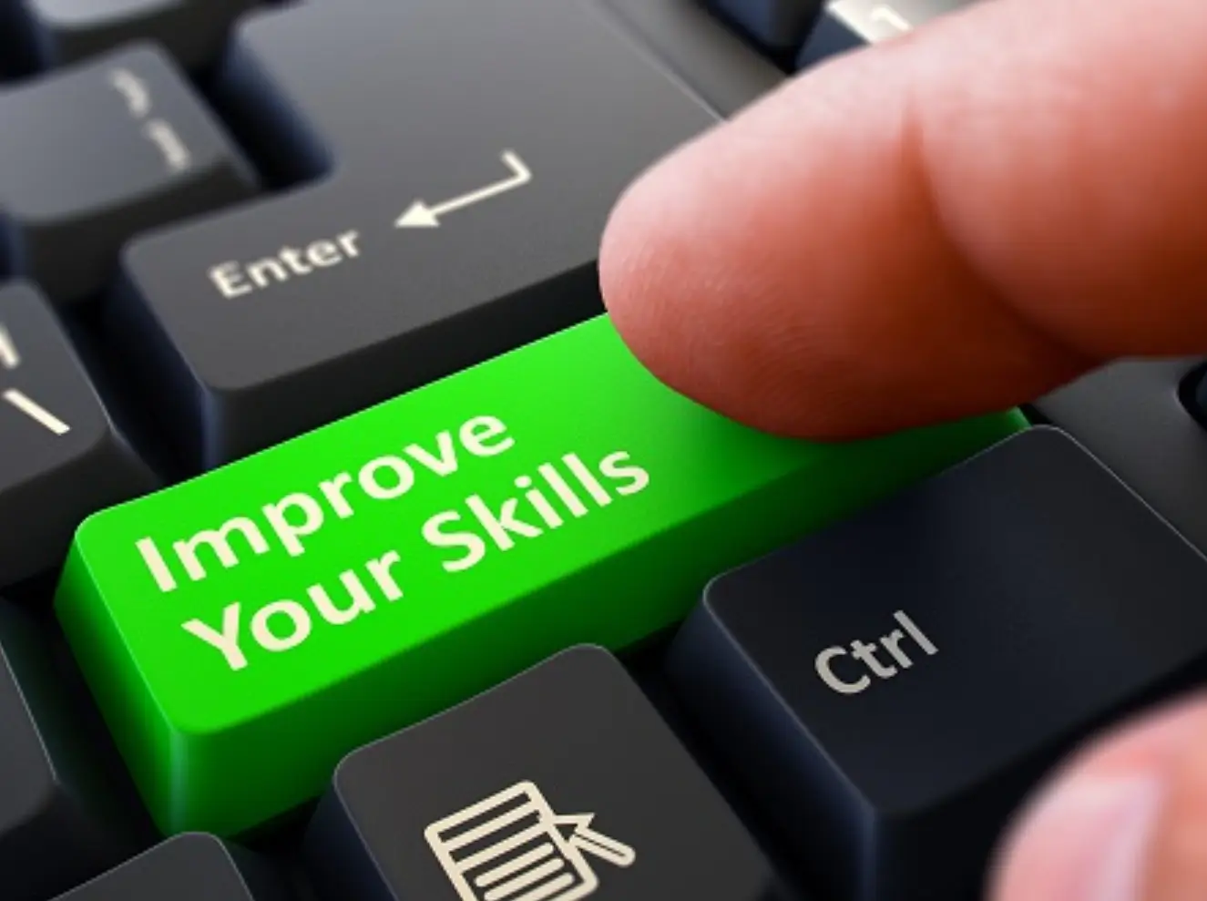 Finger presses green keyboard button Improve Your Skills.