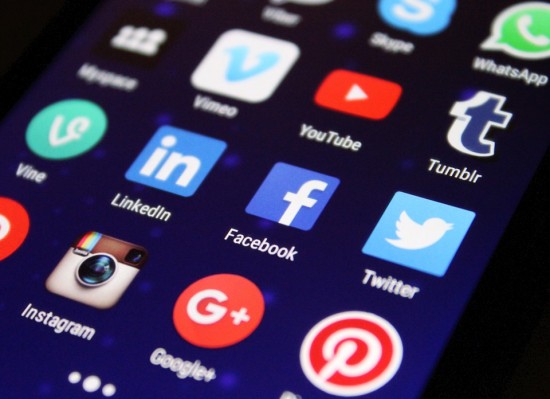 Close up of Twitter, YouTube, Facebook, Google+, Pinterest, Vimeo, Instagram and Tumblr icons on a phone