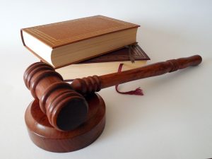 A judge's hammer and two law books